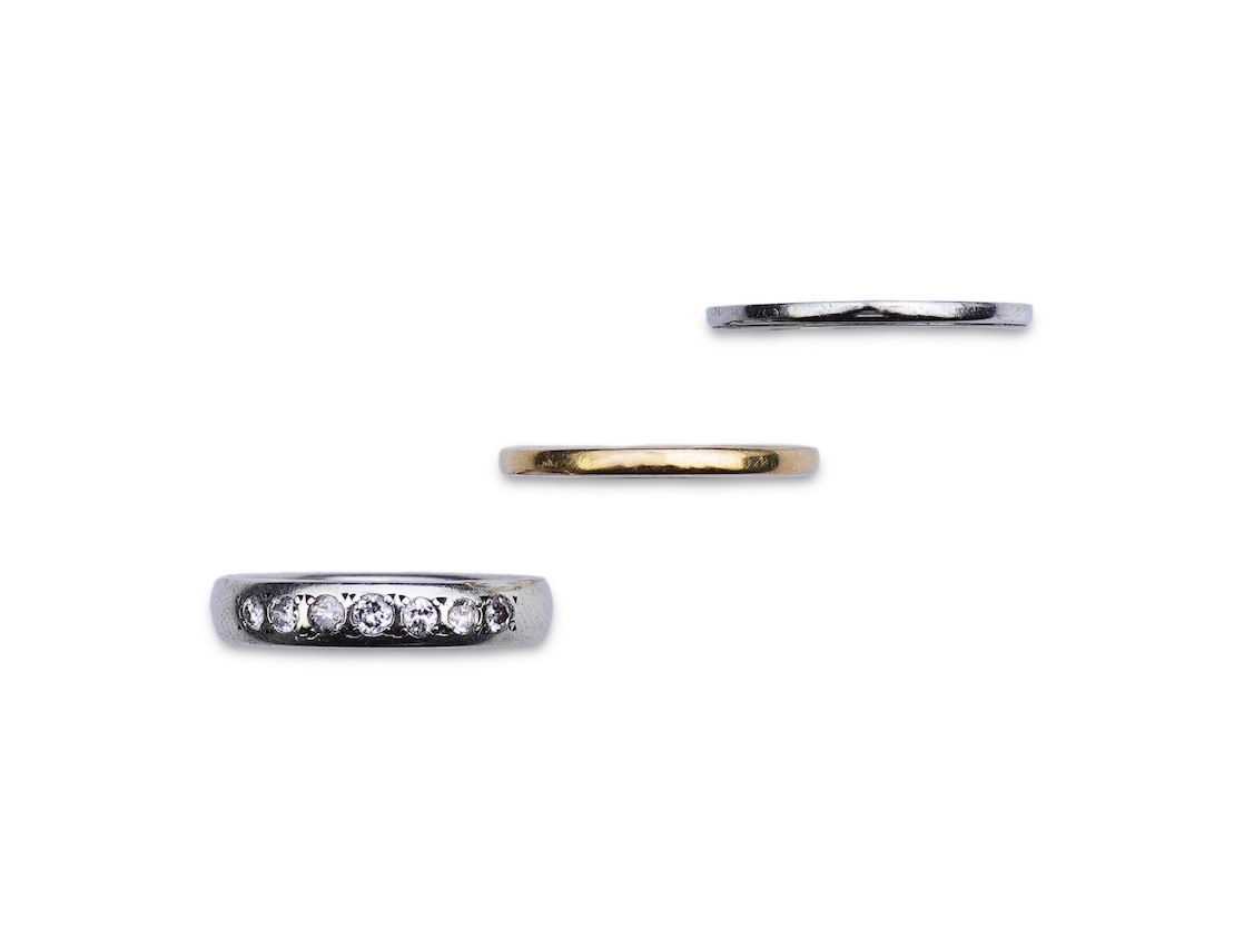 A diamond ring and two gold wedding rings